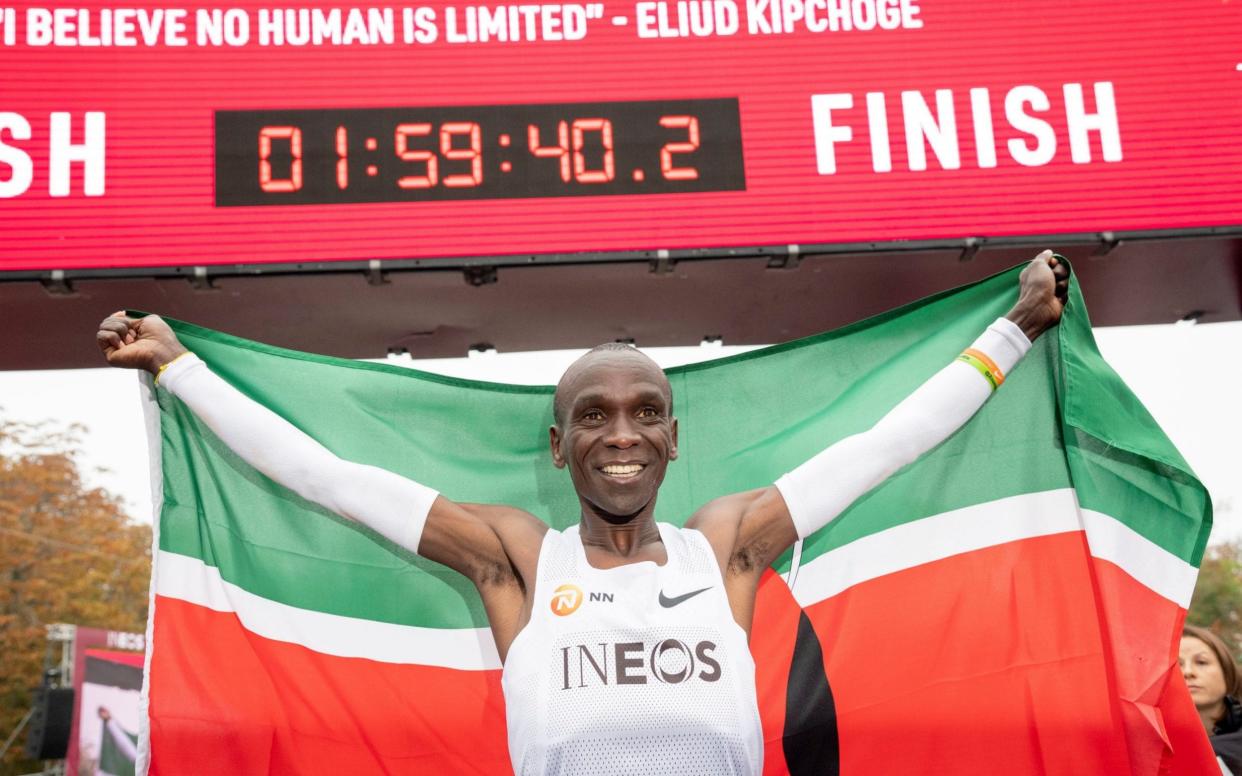 Eliud Kipchoge, Kenyan marathon world record holder, celebrates with the flag of Kenya in front of the finish line after the INEOS 1:59 Challenge in Vienna - REX