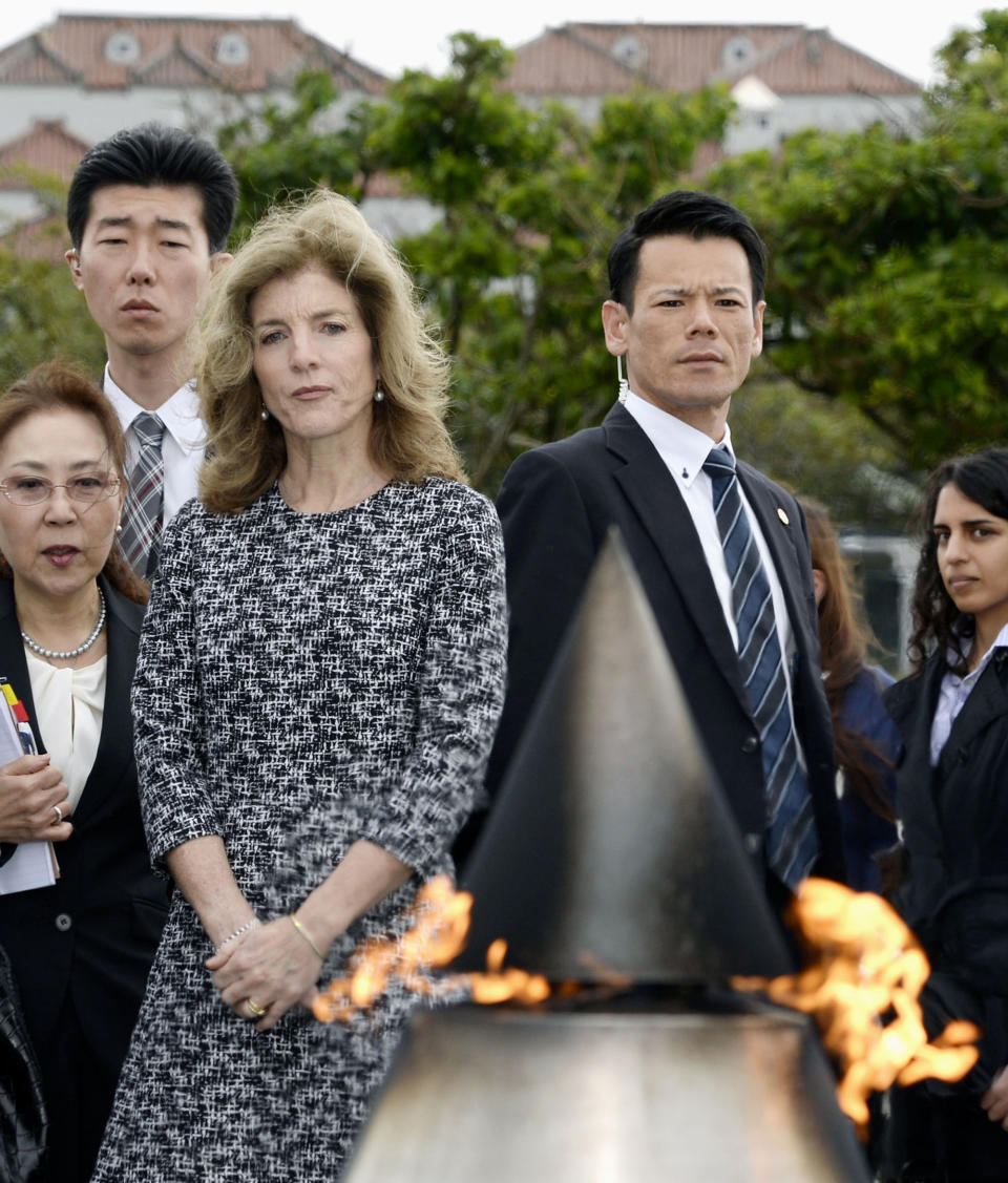 U.S. Ambassador Caroline Kennedy, front left, watches a flame on the Cornerstone of Peace at the Peace Memorial Park in Itoman, Okinawa Wednesday, Feb. 12, 2014. Kennedy,who arrived later Tuesday, is to meet with Okinawan officials and may see the base relocation site during her three-day visit, Kyodo News agency reported. (AP Photo/Kyodo News) JAPAN OUT, MANDATORY CREDIT