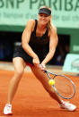 PARIS, FRANCE - JUNE 09: Maria Sharapova of Russia plays a backhand in the women's singles final against Sara Errani of Italy during day 14 of the French Open at Roland Garros on June 9, 2012 in Paris, France. (Photo by Matthew Stockman/Getty Images)