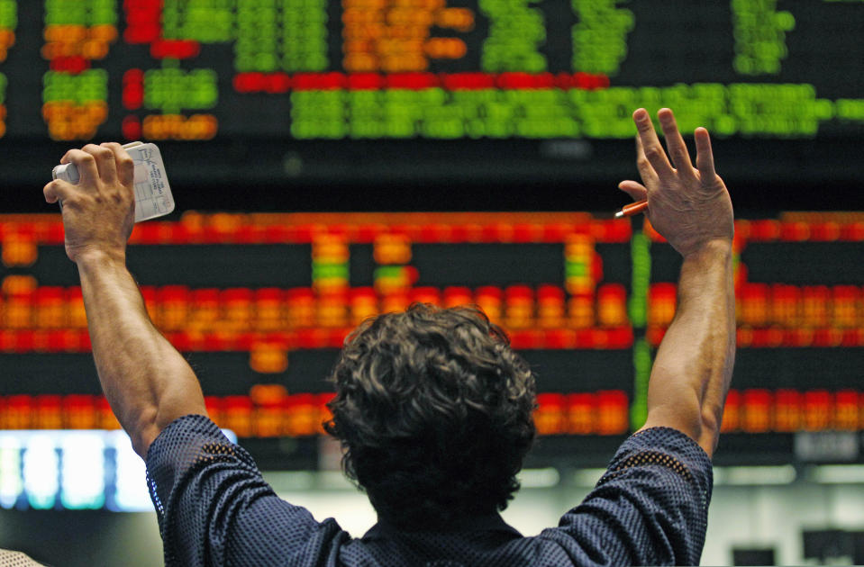 FILE - In this Sept. 21, 2011 file photo, a trader at the CME Group signals in the S&P 500 Futures pit in Chicago. Most states are doing a poor job tracking whether their tax breaks for businesses are actually spurring job growth, including some that have poured hundreds of millions of dollars into corporate incentive programs even while grappling with record deficits, according to a new report released Thursday, April 12, 2012 by the Pew Center on the States. Late last year Illinois agreed to a package of $330 million in tax breaks for Sears Holding Corp. and two companies that operate Chicago financial exchanges, CME Group Inc. and CBOE Holdings Inc., after they threatened to leave the state. (AP Photo/M. Spencer Green, File)