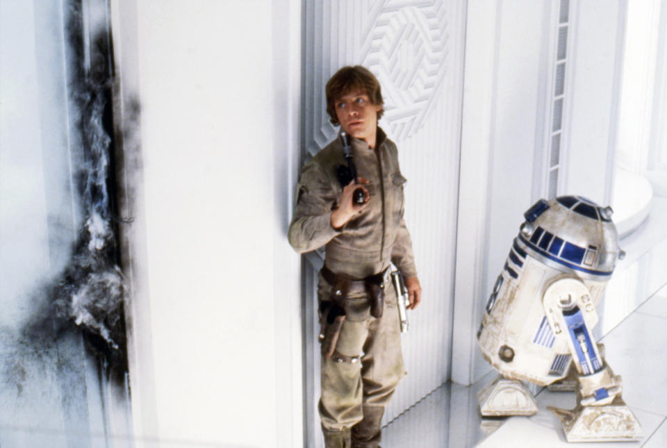 Mark Hamill and R2-D2 on the set of 'Star Wars: Episode V - The Empire Strikes Back', directed by Irvin Kershner. (Photo by Lucasfilm/Sunset Boulevard/Corbis via Getty Images)