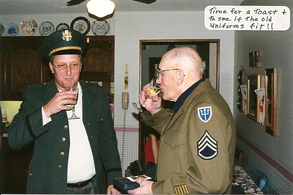 Father and son could still get in their uniforms as they shared a toast a few years back.