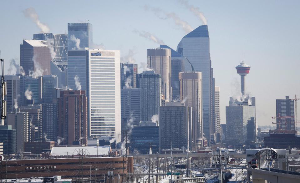 Steam rises from buildings in Calgary, Alta., Wednesday, Feb. 8, 2017. A major player in Calgary's depressed office real estate industry is putting 56 office buildings under court protection from creditors while it tries to find buyers. THE CANADIAN PRESS/Jeff McIntosh