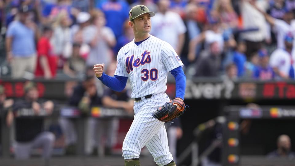 New York Mets pitcher David Robertson (30) reacts to getting the final out against the Cleveland Guardians during the ninth inning