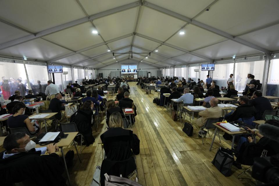 Lawyers attend the opening of the first hearing of the trial for the Morandi bridge collapse at the Genoa's Palace of Justice Thursday, July 7, 2022. Forty-three people were killed when a large stretch of the Morandi Bridge broke off, August 14, 2018, on the eve of one of Italy's biggest vacation holidays. (AP Photo/Antonio Calanni)