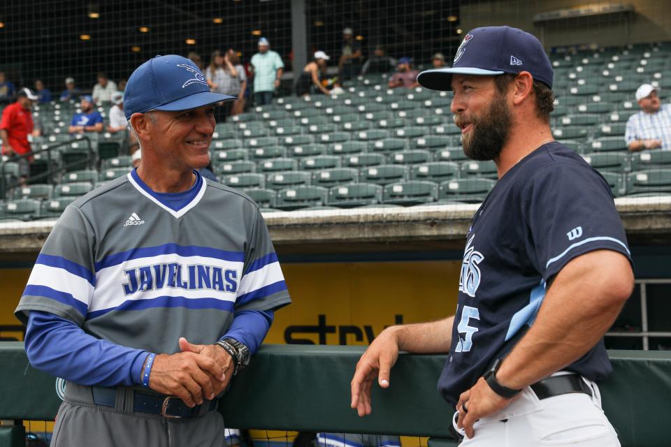 Texas A&M-Kingsville head baseball coach Jason Gonzales speaks to Hooks manager Joe Thon before the exhibition game at Whataburger Field on April 4, 2023, in Corpus Christi, Texas.