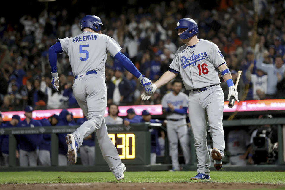 Los Angeles Dodgers' Freddie Freeman (5) is congratulated by Will Smith (16) for a home run against the San Francisco Giants during the third inning of a baseball game in San Francisco, Friday, Sept. 29, 2023. (AP Photo/Jed Jacobsohn)