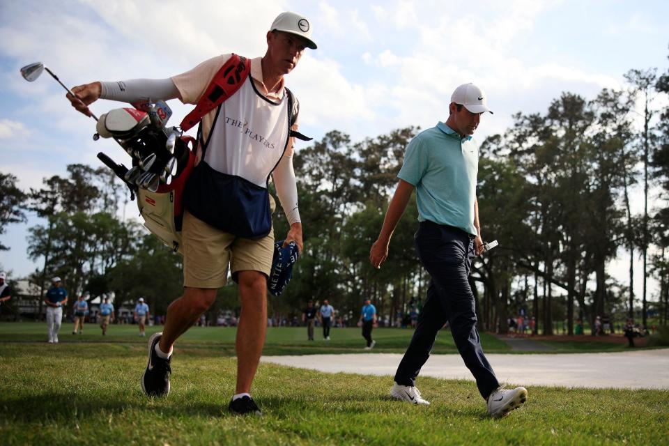 Scottie Scheffler (right) and caddie Ted Scott walk up the 15th fairway of the Players Stadium Course at TPC Sawgrass during the final round in 2023.