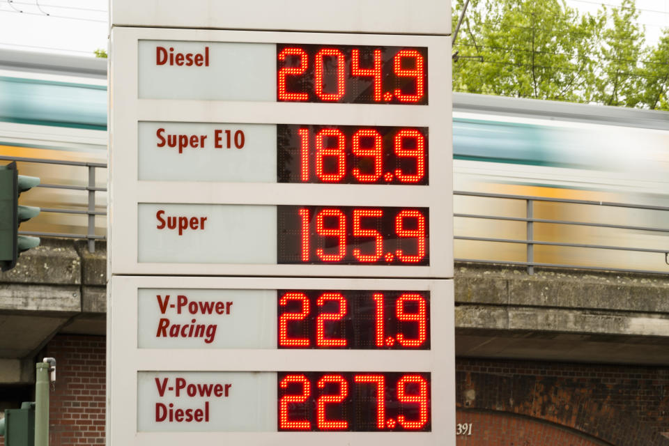 A public transport train drive behind a display with fuel prices at a gas station et in Berlin, Germany, Sunday, June 19, 2022. People across the world are confronted with higher fuel prices as the war in Ukraine and lagging output from producing nations drive prices higher. Drivers are looking at the numbers on the gas pump and rethinking their habits and finances, pushing some to walk, bike or use public transport. (AP Photo/Markus Schreiber)