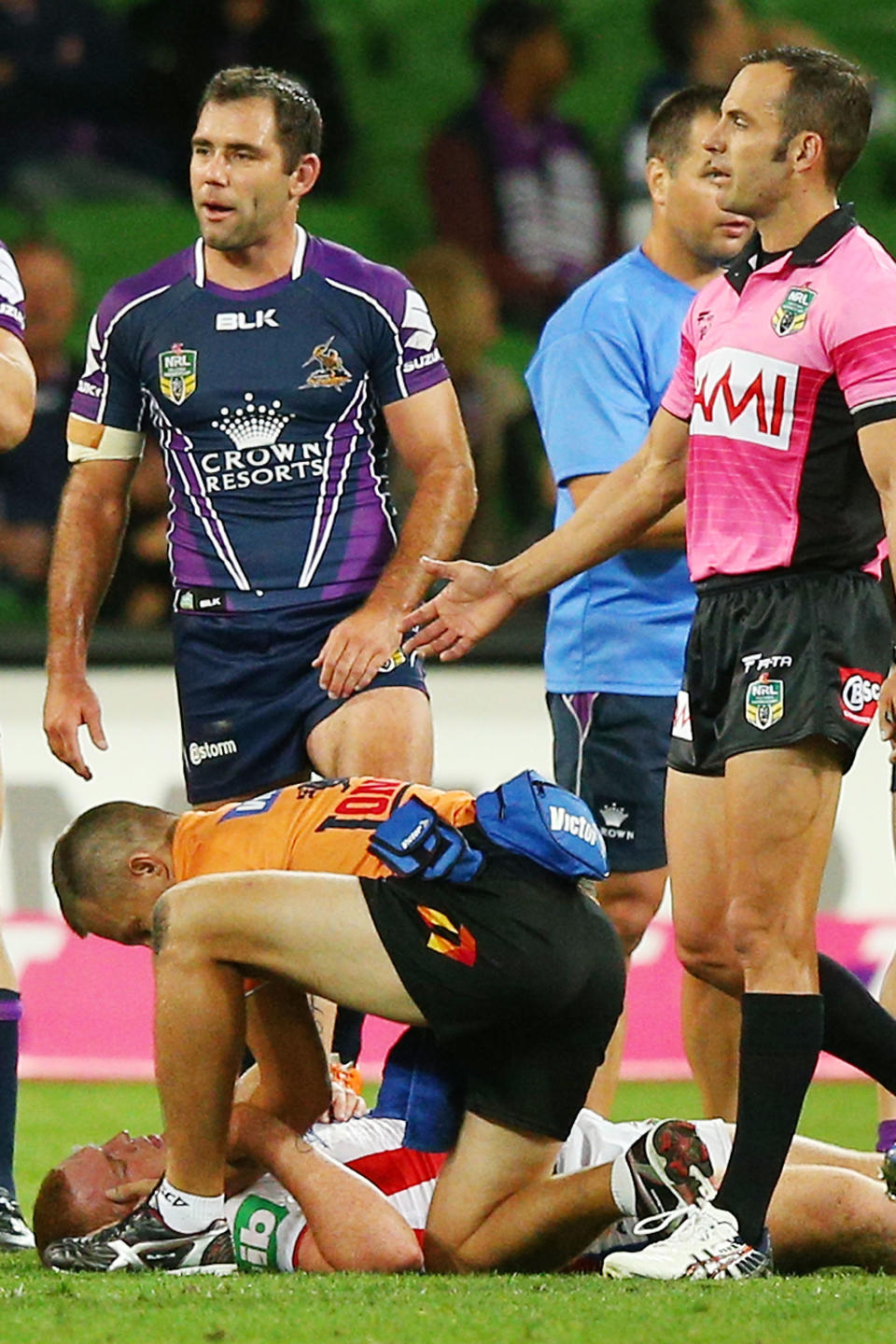 MELBOURNE, AUSTRALIA - MARCH 24:  Alex McKinnon of the Knights lays on the ground after being tackled as Cameron Smith of the Storm look on during the round three NRL match between the Melbourne Storm and the Newcastle Knights at AAMI Park on March 24, 2014 in Melbourne, Australia.  (Photo by Michael Dodge/Getty Images)