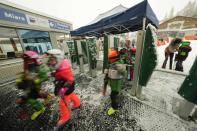 Children enter to board gondolas for Plan de Corones ski area, in San Vigilio di Marebbe, Italy South Tyrol, Saturday, Nov. 27, 2021. After nearly two years of being restricted to watching snow accumulate on distant mountains, Italian skiers are finally returning to the slopes that have been off limits since the first pandemic lockdown in March 2020. But just as the industry is poised to recover from a lost 2020-2021 season after an abrupt closure the previous year, a spike in cases in the Alpine province bordering Austria is underlining just how precarious the situation remains. (AP Photo/Luca Bruno)