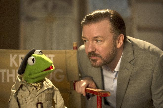 This image released by Disney shows the muppet character Kermit the frog, left, and Ricky Gervais in a scene from "Muppets Most Wanted." (AP Photo/Disney Enterprises, Inc., Jay Maidment)
