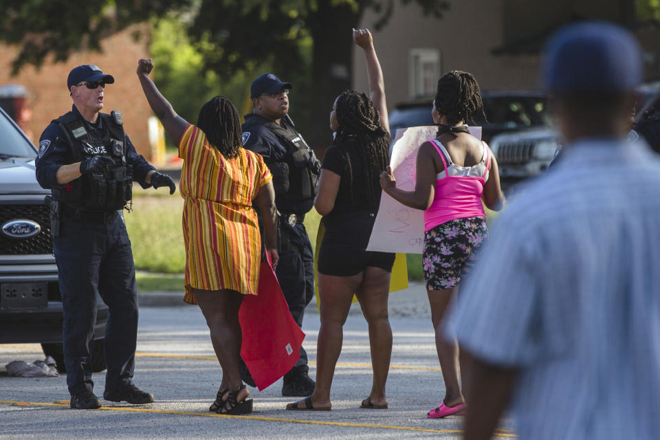FILE - Brittany Martin, second from left, wearing striped clothing, confronts police before demonstrators in support of George Floyd march with an escort around downtown Sumter, S.C., on May 31, 2020. Martin, a pregnant Black activist serving four years in prison over comments she made to police during racial justice protests in the summer of 2020, will not receive a lesser sentence, a judge has ruled. (Micah Green/The Item via AP, File)