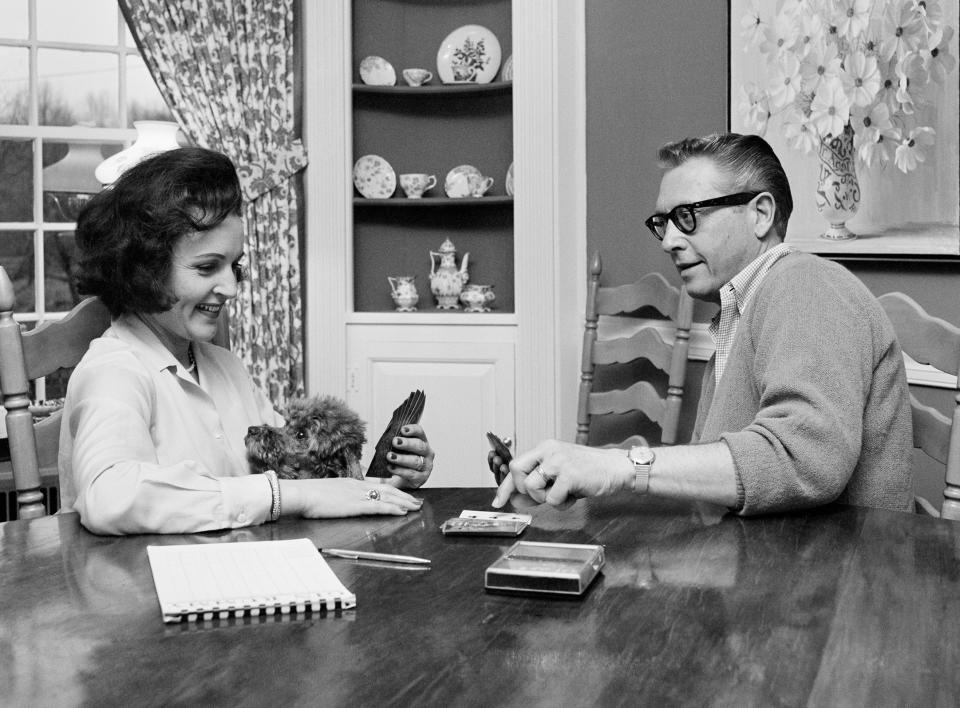 FILE - Allen Ludden and his wife Betty White plays a game of cards in their home in Westchester, N.Y. on April 29, 1965. Betty White, whose saucy, up-for-anything charm made her a television mainstay for more than 60 years, has died. She was 99. (AP Photo/Bob Wands, File)