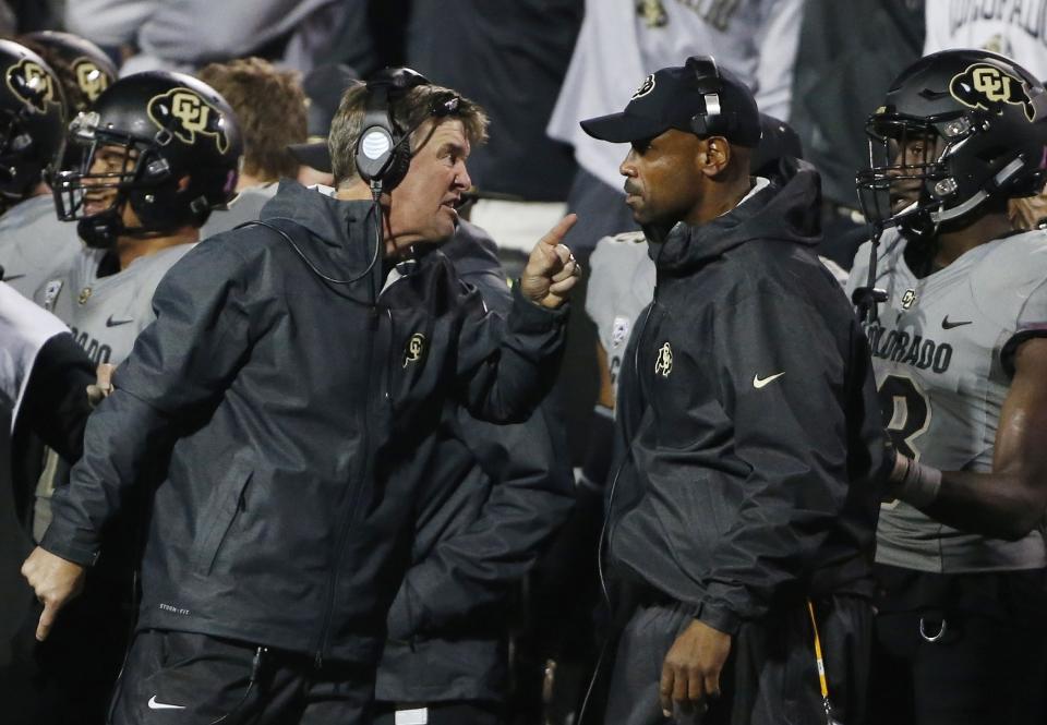 FILE – In this Oct. 3, 2015, file photo, Colorado head coach Mike MacIntyre, left, has heated words with assistant coach Joe Tumpkin during a game against Oregon. (AP Photo/Brennan Linsley, File)