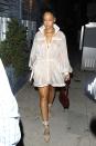 <p>In a sheer raincoat, Fenty x Puma sandals and holding a red python-skin purse while out in LA. </p>