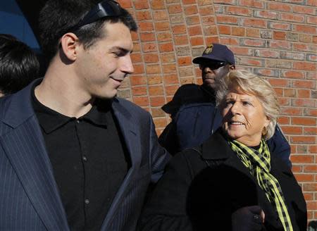 Patricia Donahue (R), wife of murder victim Michael Donahue, gets a pat on the back from her grandson Shawn outside the courthouse on the first of two days of convicted mobster James "Whitey" Bulger's sentencing hearing in Boston, Massachusetts November 13, 2013. REUTERS/Brian Snyder