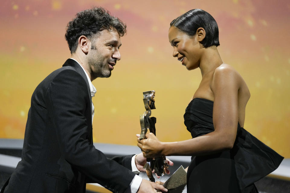 Jury Member Rodrigo Sorogoyen, left, is seen presenting Taylor Russell the Marcello Mastroianni award for best young actress for the film 'Bones and All' at the closing ceremony of the 79th edition of the Venice Film Festival in Venice, Italy, Saturday, Sept. 10, 2022. (AP Photo/Domenico Stinellis)