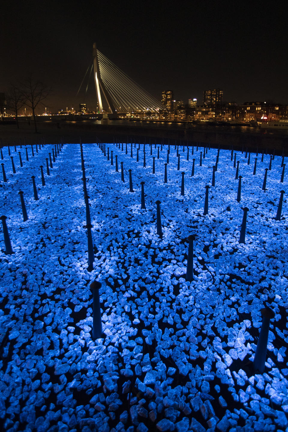 The monument Levenslicht, or Light of Life, by artist Daan Roosegaarde, consisting of 104,000 light-emitting stones for the number of Dutch Holocaust victims is unveiled in Rotterdam, Netherlands, Thursday, Jan. 16, 2020, to mark the 75th anniversary, later this month, of the liberation of Auschwitz concentration and extermination camp. (AP Photo/Peter Dejong)