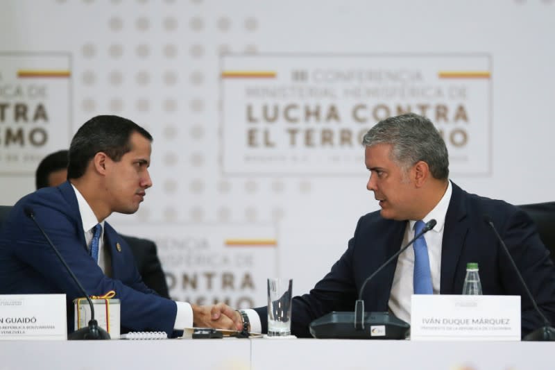 Colombia's President Ivan Duque and Venezuelan opposition leader Juan Guaido, who many nations have recognised as the country's rightful interim ruler, shake hands during the III Hemispheric Anti-Terrorism Ministerial Conference, in Bogota