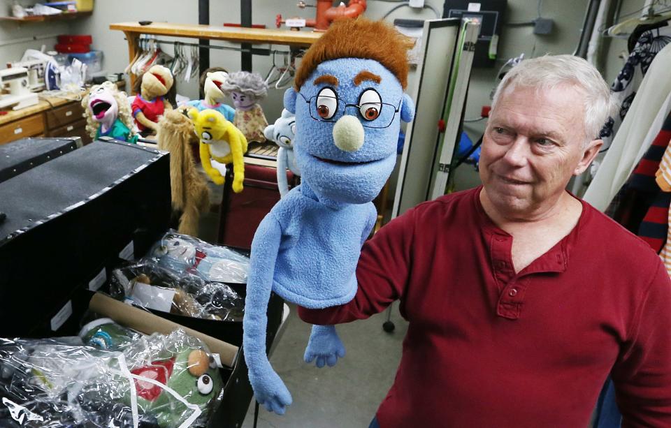 Stan Rabe, the producer of the Avenue-Q, shows puppet characters from New York City for the performance of the Avenue Q musical puppet show at Actors Ames Community Theater on Thursday, Oct. 26. 2023, in Ames, Iowa.