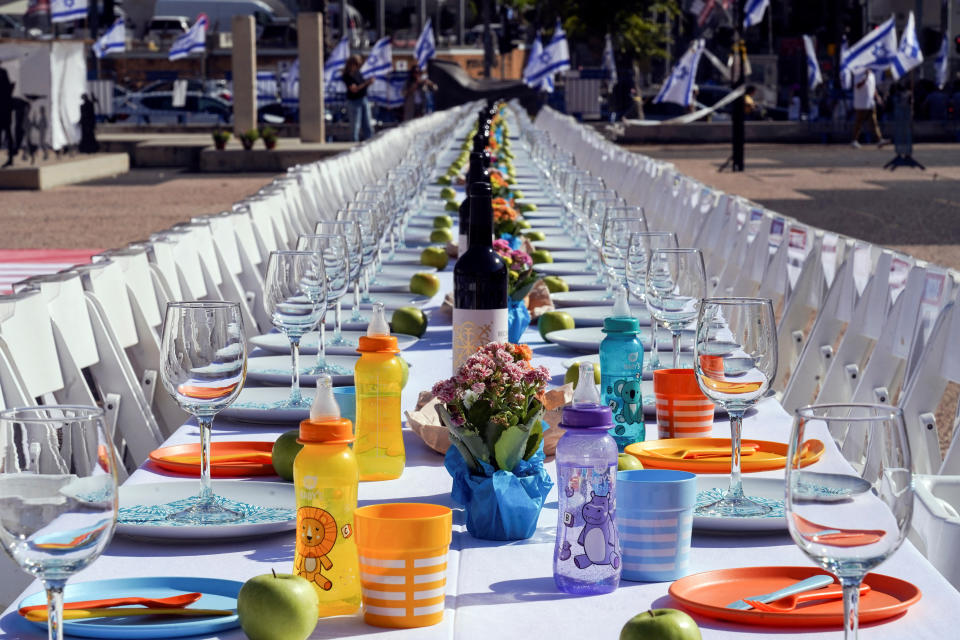 A dinner table is set with empty chairs that symbolically represent hostages and missing people with families that are waiting for them to come home, following a deadly infiltration by Hamas gunmen from the Gaza Strip, in Tel Aviv, Israel October 20, 2023. REUTERS/Janis Laizans