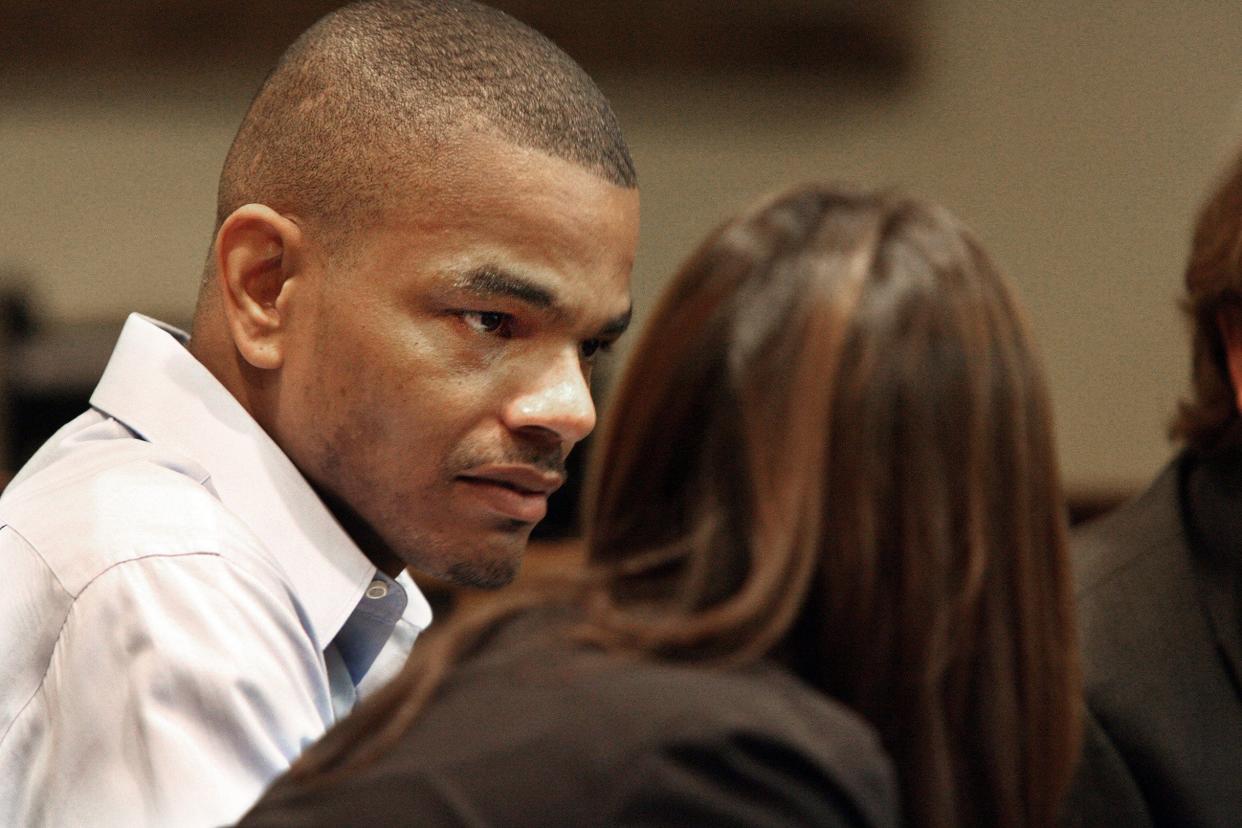 Defendant Jessie Dotson talks with defense team members as his murder trial continues in Judge James Beasley's courtroom on September 29, 2010.