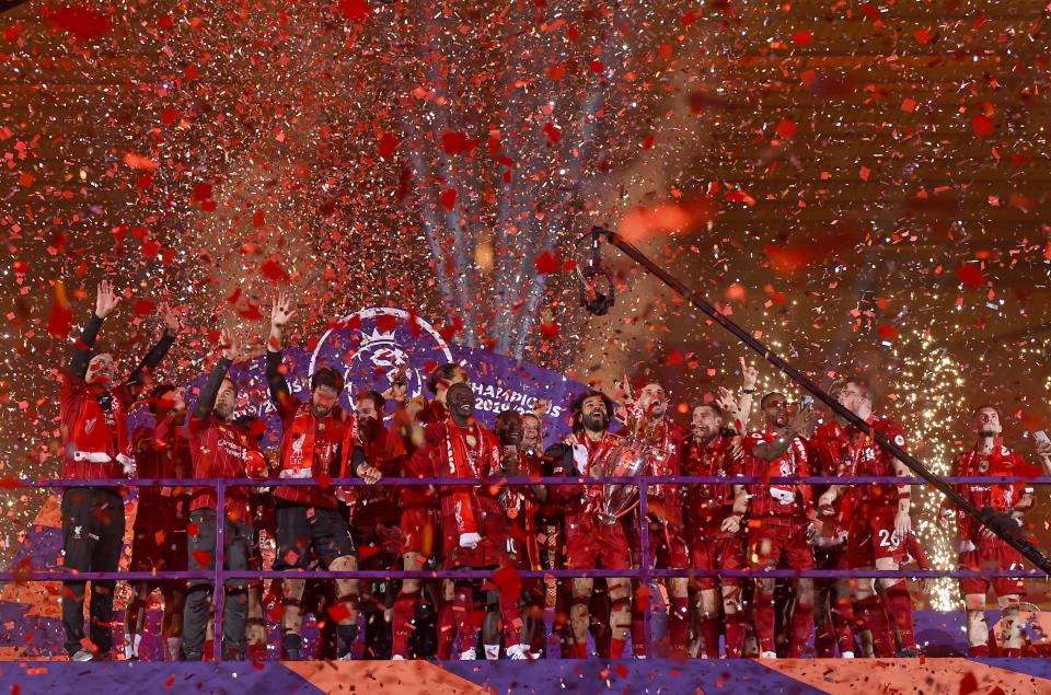 Liverpool players celebrate with the English Premier League trophy after it was presented following the Premier League soccer match between Liverpool and Chelsea at Anfield stadium in Liverpool, England, Wednesday, July 22, 2020. (Paul Ellis, Pool via AP)