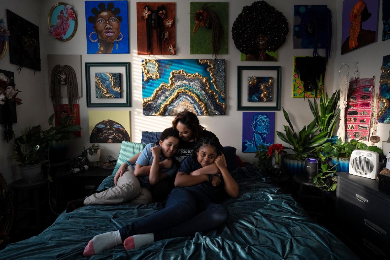 Jasmine Wooten sits with her two children, 8-year-old Arius, left, and 11-year-old Naomi on her bed in their home on the city's Near East Side. Emergency SNAP benefits helped to feed the single mother and her family during the COVID-19 pandemic, but those benefits will end in March.