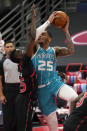 Charlotte Hornets forward P.J. Washington (25) shoots over Toronto Raptors forward Chris Boucher during the second half of an NBA basketball game Saturday, Jan. 16, 2021, in Tampa, Fla. (AP Photo/Chris O'Meara)