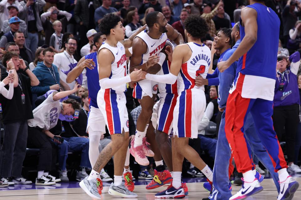 Pistons guard Alec Burks celebrates with his team after making a 3-point shot at the end of the fourth quarter in the Pistons' 154-148 overtime loss on Wednesday, Jan. 3, 2024, in Salt Lake City.