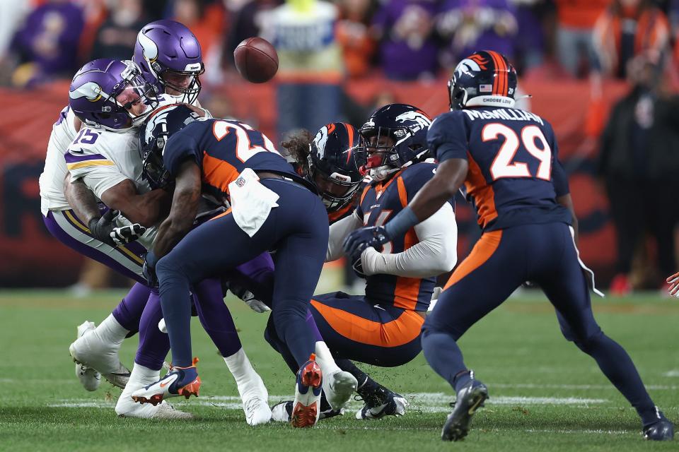 Vikings QB Joshua Dobbs (15) fumbles the football after being tackled by the Broncos' Kareem Jackson. Jackson was suspended four games for the hit.
