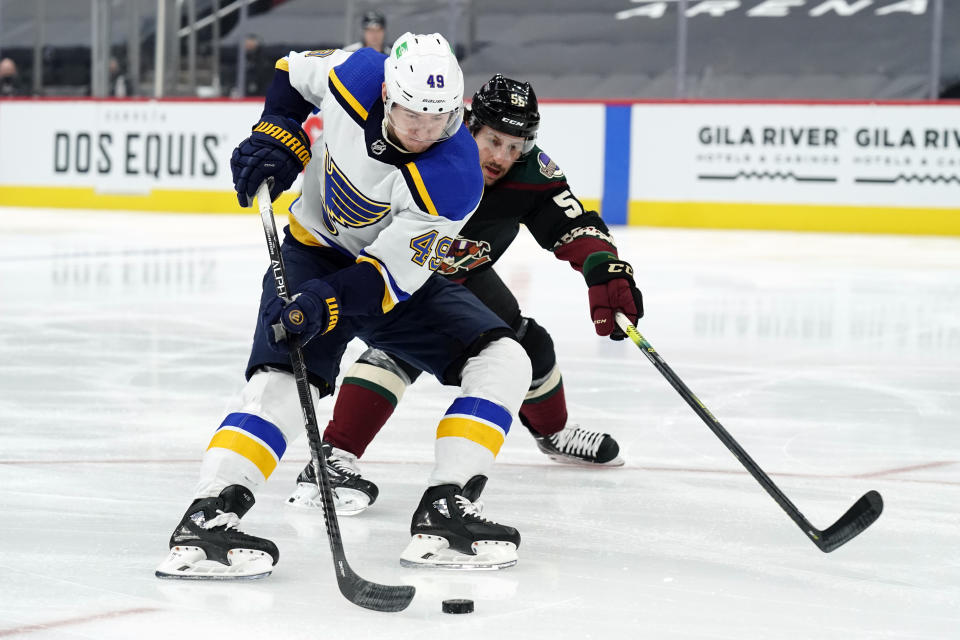 St. Louis Blues center Ivan Barbashev (49) shields Arizona Coyotes defenseman Jason Demers from the puck in the first period during an NHL hockey game, Monday, Feb. 15, 2021, in Glendale, Ariz. (AP Photo/Rick Scuteri)