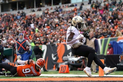 New Orleans Saints running back Alvin Kamara (41) scores a touchdown as he avoids Cincinnati Bengals defensive end Sam Hubbard (94) in the first half at Paul Brown Stadium - Credit: Aaron Doster/USA Today