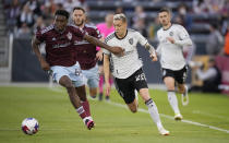 Colorado Rapids defender Moïse Bombito, left, holds off San Jose Earthquakes forward Benji Kikanovic as they pursue the ball during the first half of an MLS soccer match Saturday, June 3, 2023, in Commerce City, Colo. (AP Photo/David Zalubowski)