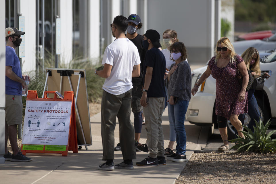 Arriving voters are given safety instructions by a poll worker at the Living Word Bible Church voting station in Phoenix, Ariz., on Election Day Tuesday, Nov. 3, 2020. (AP Photo/Dario Lopez-MIlls)