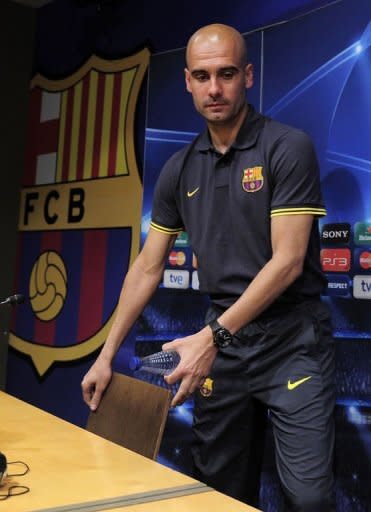 Barcelona's coach Josep Guardiola arrives to give a press conference at the Camp Nou stadium in Barcelona, on the eve of their Champions League semi-final second leg match against Chelsea