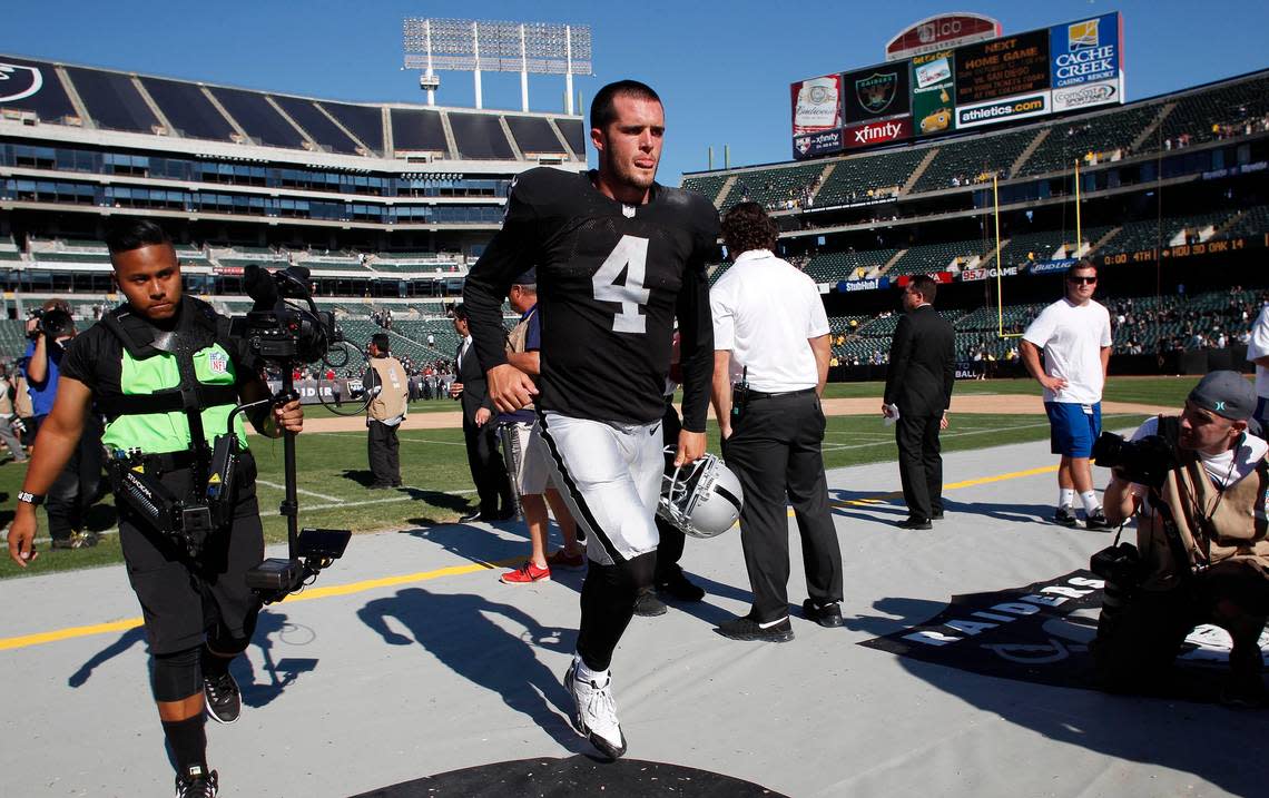 Derek Carr walks off the field at the end of an NFL game against the Houston Texans Sunday, Sept. 14, 2014, in Oakland, Calif.