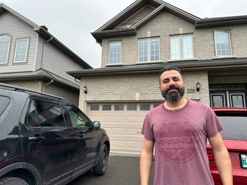 Sam Dalbah stands outside his Orleans home a few days after removing an empty nest 