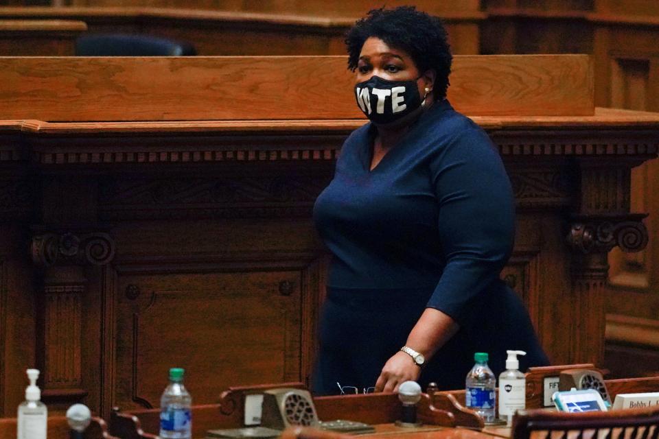 Democrat Stacey Abrams, walks on Senate floor before of members of Georgia's Electoral College cast their votes at the state Capitol, Monday, Dec. 14, 2020, in Atlanta. (AP Photo/John Bazemore, Pool)