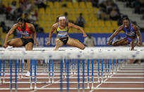 (L-R) Virginia Powell-Crawford, Lolo Jones and Danielle Carruthers of the US compete in the women's 100m hurdles at the IAAF Diamond League in Doha on May 6, 2011. (KARIM JAAFAR/AFP/Getty Images)