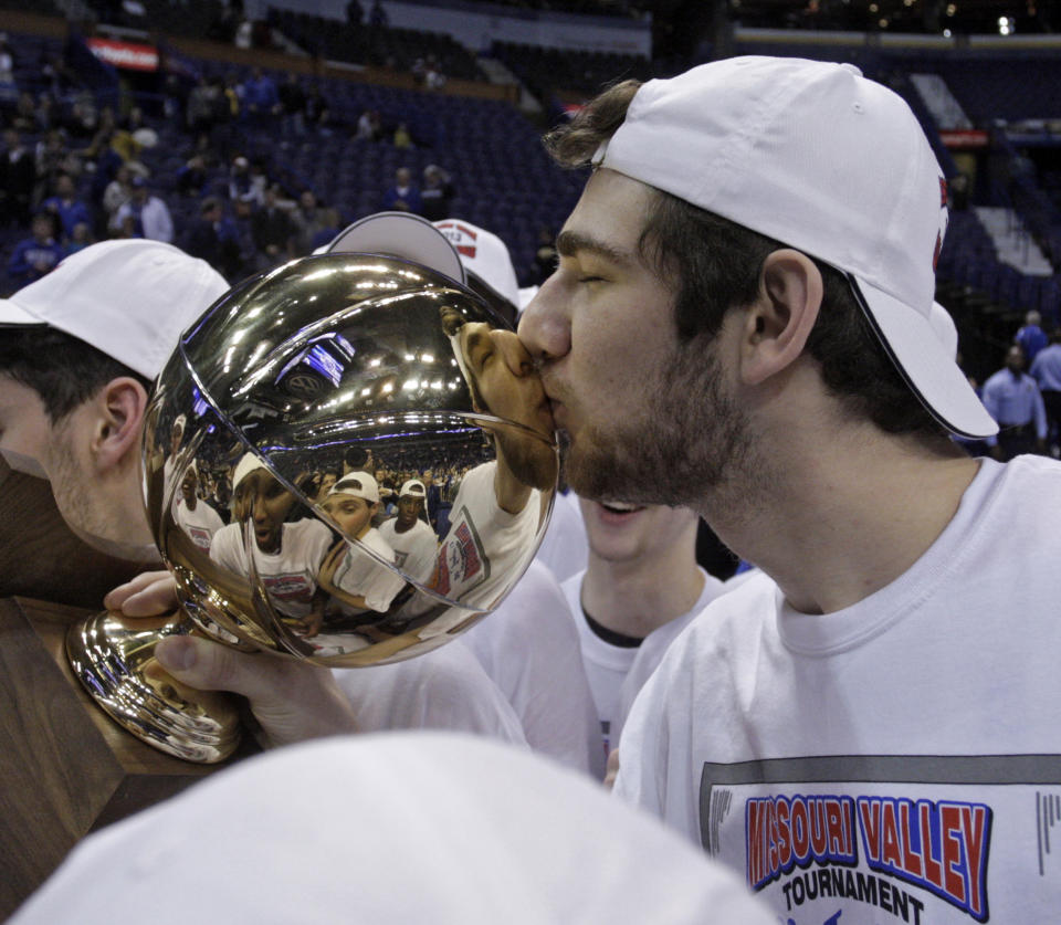 Creighton's Will Artino kisses the championship trophy after his team defeated Wichita State 68-65 for the Missouri Valley Conference tournament championship in an NCAA college basketball game on Sunday, March 10, 2013, in St. Louis. (AP Photo/Tom Gannam)