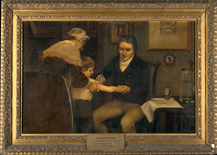 <span class="caption">Edward Jenner performing the ‘first’ vaccination.</span> <span class="attribution"><a class="link " href="https://commons.wikimedia.org/w/index.php?curid=8776638" rel="nofollow noopener" target="_blank" data-ylk="slk:Ernest Board/Wikimedia Commons;elm:context_link;itc:0;sec:content-canvas">Ernest Board/Wikimedia Commons</a></span>