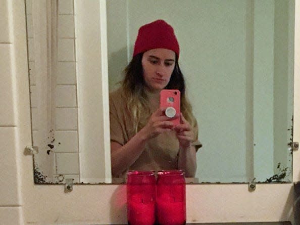 The author taking a mirror selfie with a hat on.