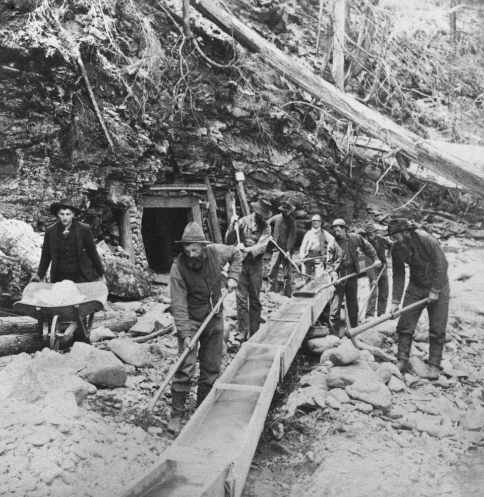 Gold prospectors mining at Lake Coeur d'Alene, Idaho, circa 1885. <a href="https://www.gettyimages.com/detail/news-photo/gold-prospectors-shovel-sand-and-gravel-into-a-rocker-box-a-news-photo/1478786322" rel="nofollow noopener" target="_blank" data-ylk="slk:Graphic House/Archive Photos via Getty Images;elm:context_link;itc:0;sec:content-canvas" class="link ">Graphic House/Archive Photos via Getty Images</a>