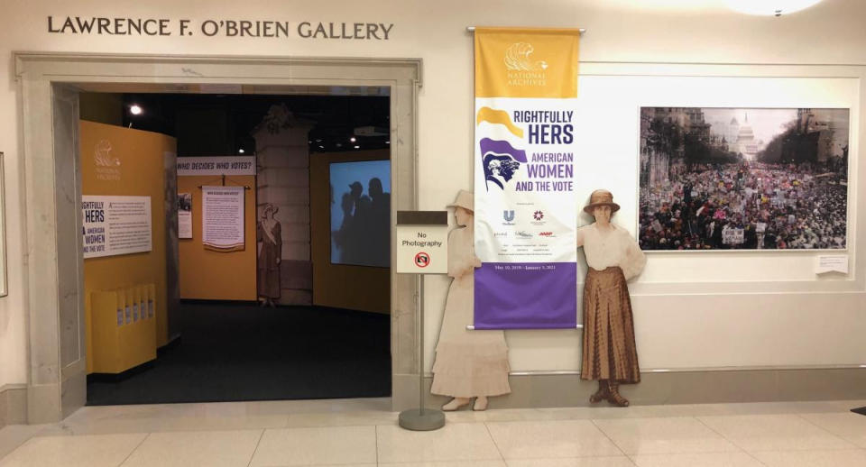 Images from the 1913 and 2017 Women's Marches were displayed as a promotional graphic in the elevator lobby outside the entrance to the 