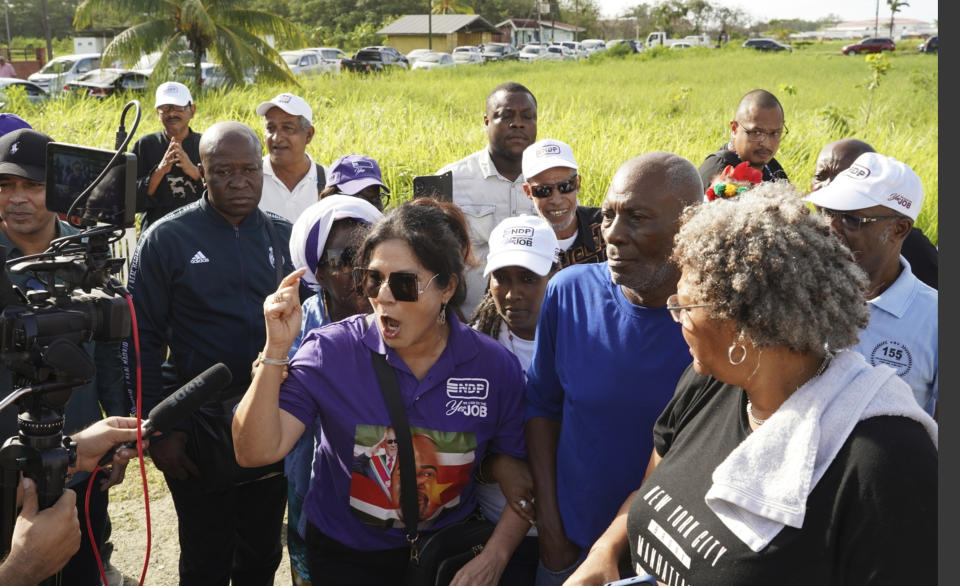 Ingrid Bouterse-Waldring, wife of Suriname's former President Desi Bouterse is surrounded by supporters as she speaks to the press outside her home in Paramaribo, Suriname, Friday, Jan. 12, 2024. The former dictator, who was sentenced to 20 years in prison in Dec. 2023 for the killings of 15 political opponents, has vanished after not turning himself in to authorities on Friday as planned. His wife told reporters that she did not know where he was and firmly stated, “He's not going to jail!" (AP Photo/Anthony Moeridjan)