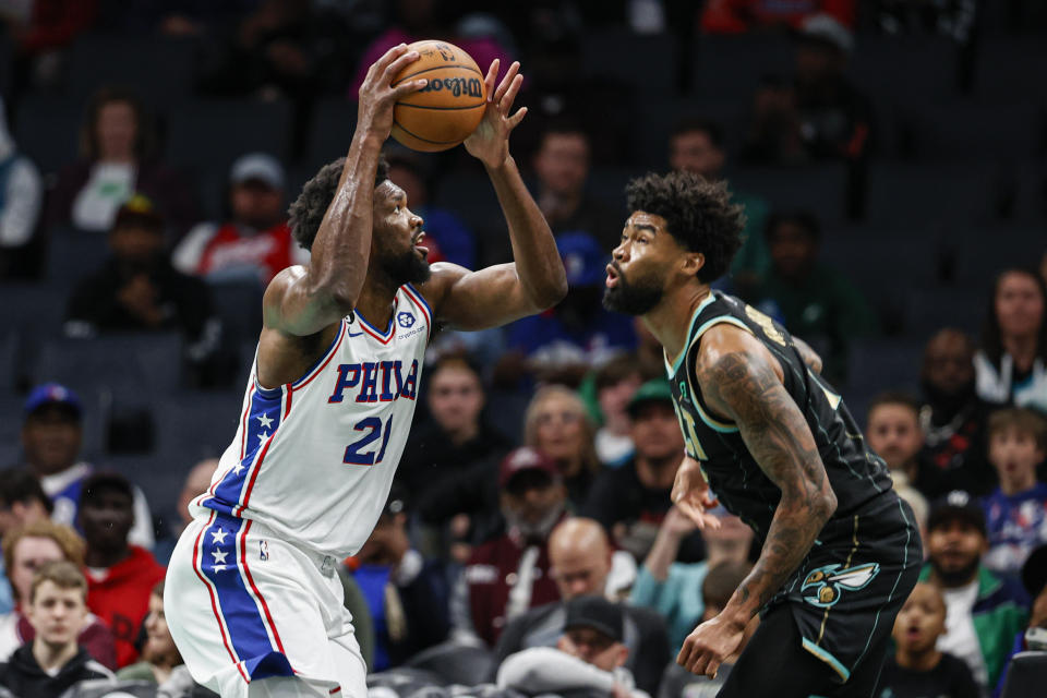 Philadelphia 76ers center Joel Embiid (21) prepares to shoot over Charlotte Hornets center Nick Richards during the first half of an NBA basketball game in Charlotte, N.C., Friday, March 17, 2023. (AP Photo/Nell Redmond)