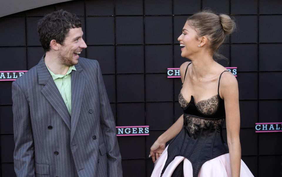 Josh O'Connor, left, and Zendaya, cast members in "Challengers," greet each other at the premiere of the film at the Regency Village Theatre, Tuesday, April 16, 2024, in Los Angeles. (AP Photo/Chris Pizzello)