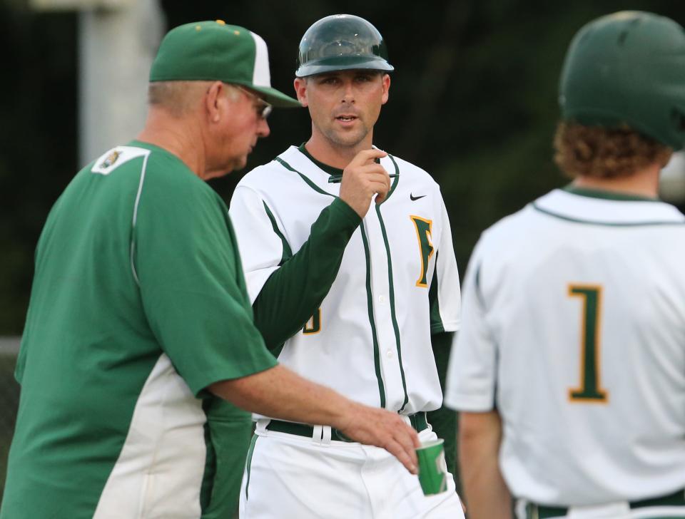 Forest's head coach Jed Yancey, center, and assistant coach, Wayne Yancey, left, walk back to the dugout with players in the first inning against Seabreeze in the 6A-2 quarterfinal game at Forest High School in Ocala, on April 29, 2015.